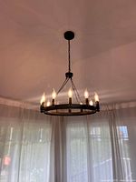 Chandelier hanging from ceiling, lights illuminated