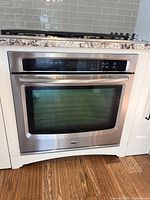 Front view of stainless Maytag wall oven installed in cabinetry