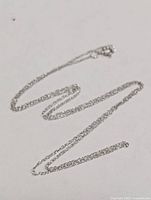 Full view of 10K gold chain loosely coiled