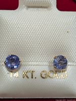 front view of earrings on card showing stones and 14 KT. GOLD text