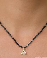 Necklace worn to show length and pendant