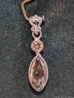 Front view of 14K white gold pendant showing marquise and round diamonds