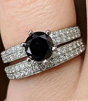 Ring set on finger showing black diamond and CZ bands
