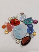 Group of assorted loose gemstones on white background