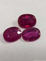 Three oval rubies on white background