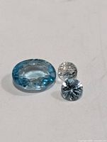 Three blue zircon gemstones loose on neutral background