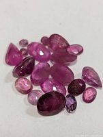 Group of faceted ruby gemstones on white background