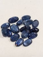 Group of fifteen oval faceted blue sapphires