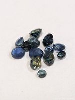 Group of approx 11 loose faceted sapphires in assorted cuts and blue hues