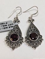 Front view of both earrings showing filigree design and garnet stones