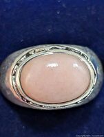 Top view showing oval pink gemstone in silver bezel