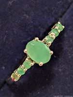 Top view showing oval emerald and side accent stones