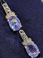 Front view of both earrings showing tanzanite stones and silver setting