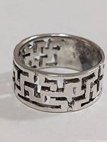 Front view of silver cut-out band ring