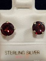 Front view showing both round garnet studs mounted in sterling silver