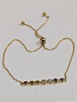 Full view of adjustable silver bracelet showing slider clasp and gemstone bar