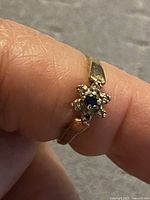 Ring on finger showing overall design and broken band