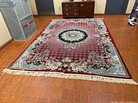 Full view of rug showing pattern, colors, and fringes