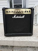 Front view of amplifier showing logo, speaker grille, control panel.