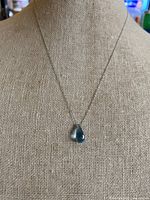 Full view of necklace on display form showing pendant drop and chain length