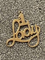 Front view of pendant showing full script "Lady" and "#1" crown detail