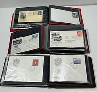 Six open albums displayed showing pages of first day cover envelopes