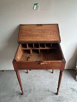 Desk with lid open showing pigeonholes and overall form