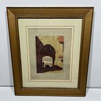 Full view of framed artwork showing wood frame and mat