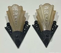 Frontal view of both sconces showing mounts and shades