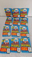Front view of all 12 sealed 1990 Fleer Baseball card packs