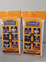 Front view of the two sealed 2024 Panini Contenders Football jumbo packs showing packaging details and 22-card count.