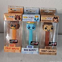 Front view of three sealed Funko Pop! PEZ Monster Cereal dispensers
