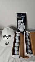 Overall lot with hat, glove package, two sleeves of golf balls