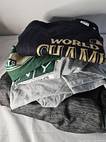 Stack of four folded sports T-shirts