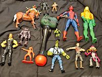 Full grouping of all figures and grabber toy laid out