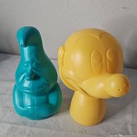 Front view of both Disney character watering cans