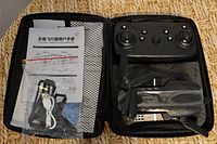 Drone, remote, accessories and manual inside zippered case