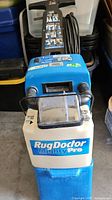 Front view of Rug Doctor Mighty Pro showing logo, tank, handle and cord