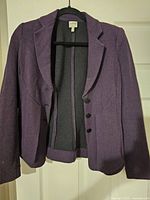 Front view of purple herringbone blazer on hanger