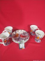 Group view of four bird-themed mugs on red background