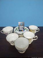 Group shot showing five teacups and six saucers
