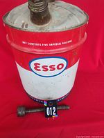 Front view of Esso oil can showing logo, capacity text and separate spout