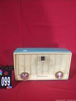 Front view showing turquoise top, cream grille, knobs, Fleetwood logo and overall appearance