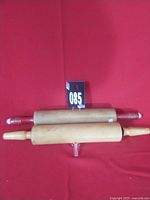 Front view of both rolling pins on red background