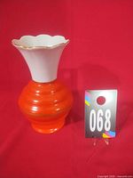 Front view of orange and white Leuchtenberg vase with lot tag