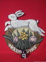 Front view of entire painted door hanger showing rabbit, flowers and text