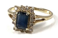 Three-quarter view of ring showing sapphire and halo stones