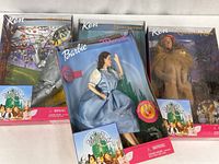 Front view of all four boxed dolls