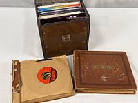 Brown vinyl tote filled with 45s; two binders, one without cover