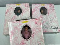 Front view of three Barbie boxes showing dolls and floral packaging